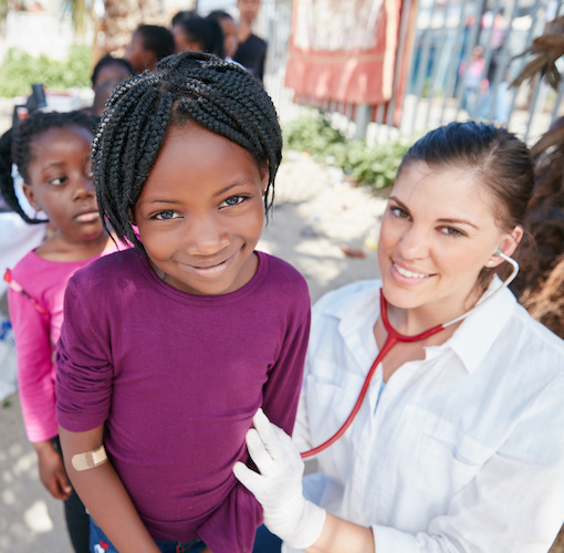 Healthy kids are happy kids. Portrait of volunteer nurses giving checkups to underprivileged kids